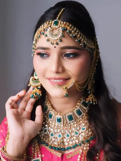A smiling bride with a complete look, including makeup, hair, and jewelry. We teach how to create a cohesive and stunning overall appearance.