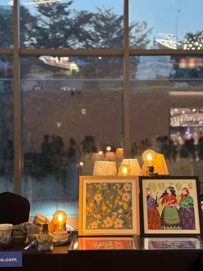 Our stall at the Lulu Mall flea market, glowing warmly as evening sets in. The lamps and artwork created a beautiful, inviting display.