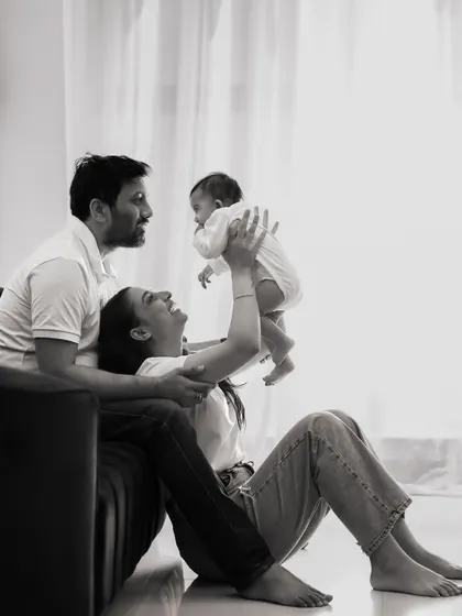Sometimes, the most powerful moments are the quiet ones. This timeless black and white photograph captures the tender, loving gaze between a mother, father, and their newborn, a memory to last a lifetime.