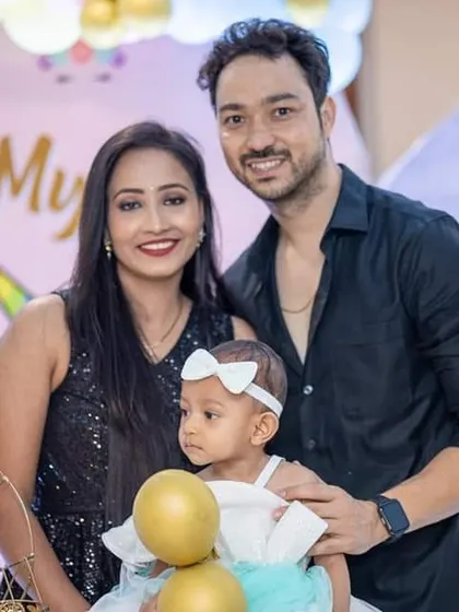 Another lovely family photo from the birthday celebration, capturing the parents' pride and joy.