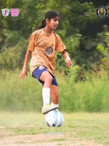 A portrait of focus. One of our players stands with her foot on the ball, calm and ready for the next play.
