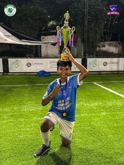 A young champion balancing the trophy on his head after our U-13 boys finished as 2nd Runners-up in the Jr. Gladiator Cup.