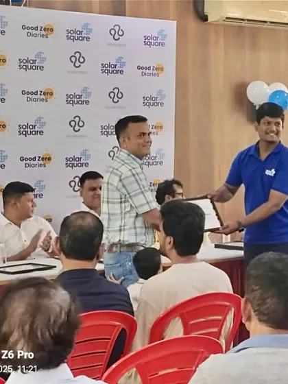 A committee member of Silver Crest receives a certificate of appreciation from our team for leading the society's transition to solar.