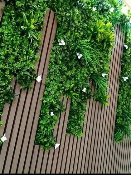 A different perspective on the vertical garden set against a slatted wood wall. The design adds a dynamic, architectural element to the space while bringing in natural textures.