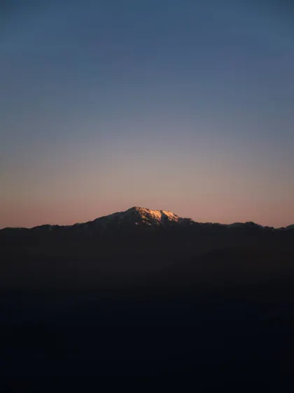 the last light of sunset on a mountain peak. this minimal color palette shows how effective a simple, focused use of color can be.