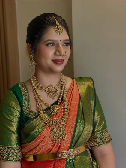 A three-quarter profile shot showcasing the bride's elegant makeup and hairstyle. The subtle contouring and highlighting enhance her features, creating a look that is perfect for wedding photography.