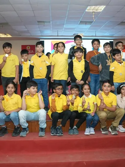 A large group of my students from one center, all winners, posing together on stage. This shows the strength and talent we have across our academy.