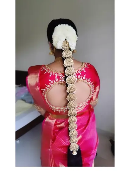 A unique floral 'Jadai' made entirely of fabric flowers, offering a lightweight yet traditional alternative to heavy metal jewellery.