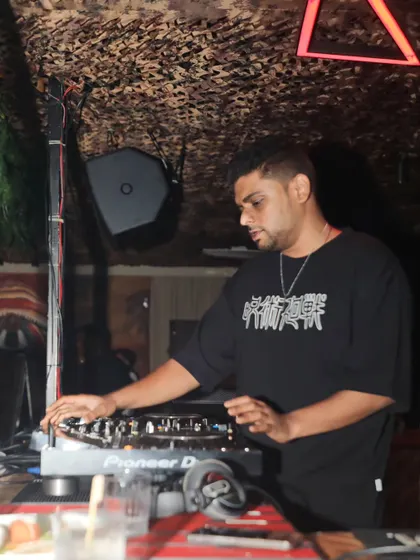 In my element, focused on the music. This shot captures my dual role as a DJ who reads the crowd and a producer who is meticulous about sound.