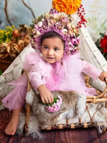Dressed in pink with a stunning floral bonnet, she looks like a little woodland princess. I love styling these sessions with beautiful outfits and accessories.