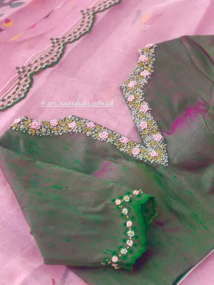 The back of the green blouse, with a floral embroidered neckline.