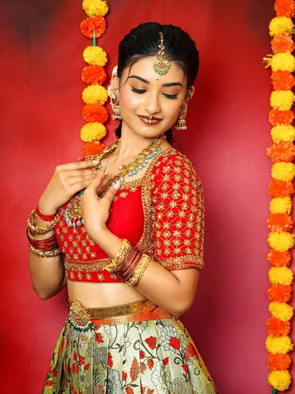 A candid moment showing the bride adjusting her necklace. This gives a great sense of the scale and detail of the jewellery.
