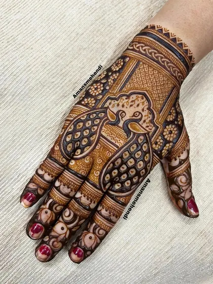 A bold back-of-hand design featuring a large, stylized peacock. The intricate details and use of negative space make this a very striking piece.