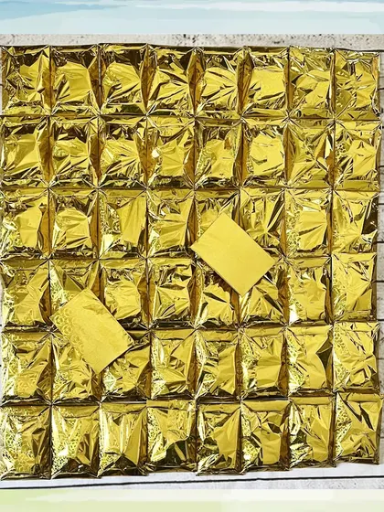 A large batch of erasers, all wrapped in gold foil for a uniform and elegant look, perfect for a more formal event.