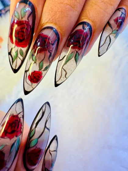 For the bride who wants something truly unique, we crafted this stained-glass rose design. Each nail is a piece of art, featuring sharp, stiletto-shaped extensions with a translucent base and hand-painted floral details that catch the light beautifully.