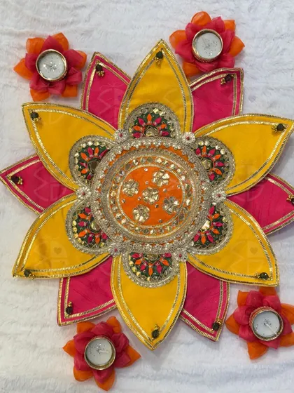 This floral rangoli platter is a beautiful and mess-free alternative to traditional rangoli. The vibrant fabric petals and central urli create an instant festive centerpiece for your floor or table.