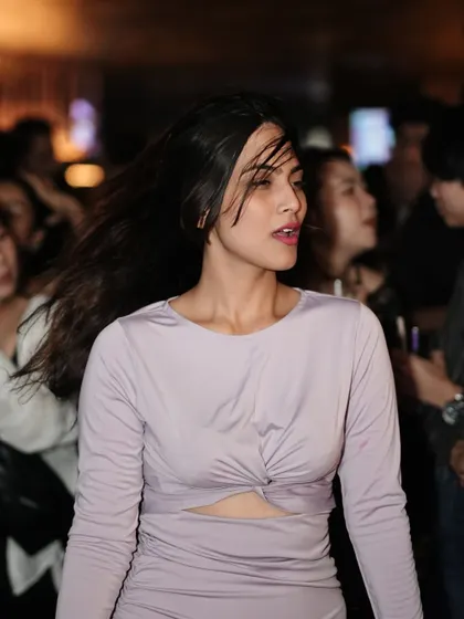 A candid shot of a guest in motion, her hair flying as she dances.