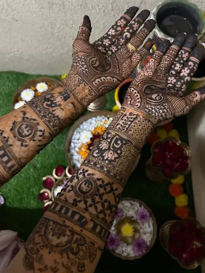 A close-up of this bride's detailed mehendi. The design includes personalized elements and traditional motifs, perfect for her wedding day.