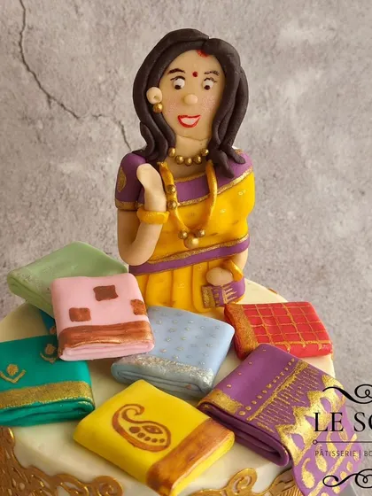 This saree-themed cake is one of my signature designs and never goes out of style. This half-kg Red Velvet cake features a beautiful figurine surrounded by a stash of tiny, hand-painted fondant sarees.