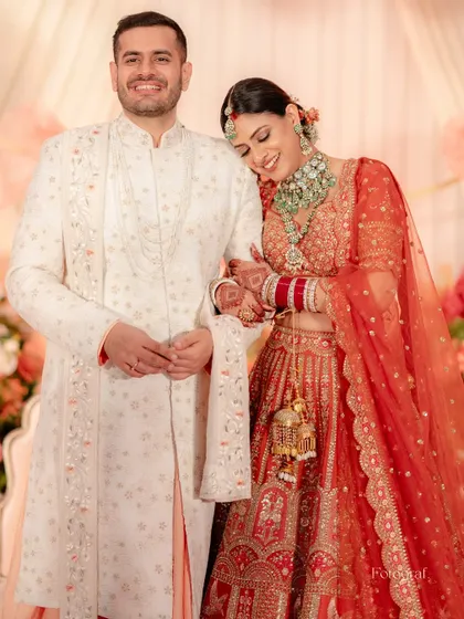 A quiet moment of connection. The bride rests her head on her groom's shoulder, a peaceful portrait from their wedding day.