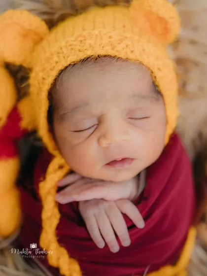 Our very own Winnie the Pooh, just one week old and already so sweet. This close-up captures his peaceful sleep next to his little Pooh bear friend.