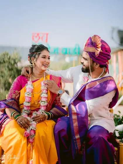 A playful and happy interaction between the bride and groom during their wedding ceremony.
