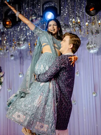 The Sangeet is all about unrestrained joy, and we are there for every moment. This candid shot of the groom lifting his bride is pure happiness, a perfect memory from a night of dance and celebration.