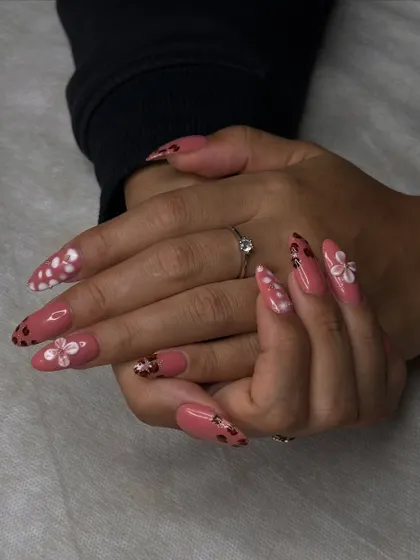 This angle showcases the full set of floral nails, demonstrating how students learn to create a cohesive and beautiful design across all ten fingers.
