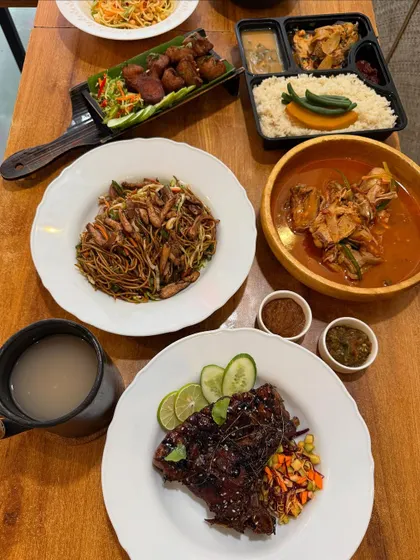 A table set for a feast, featuring a wide variety of our dishes from pork ribs and noodles to a full Naga thali. This is how we celebrate special moments.