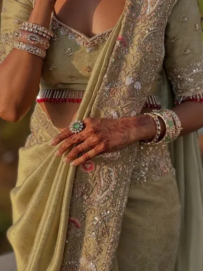 A close-up of the intricate embroidery on the saree and blouse, perfectly showcased by the clean drape.