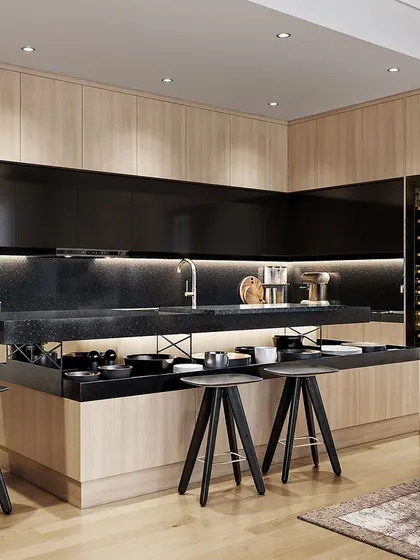 The kitchen area connected to the living room, featuring a sleek black-and-wood design with an integrated wine fridge and countertop seating.