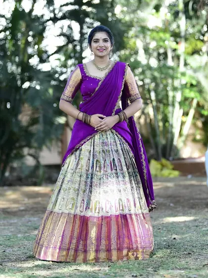 A full-length view of the gorgeous Paithani lehenga, showing the rich border and pleated skirt.