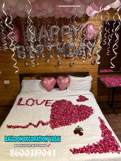 The full view of this farmhouse room decoration shows how the pink and white balloons and rose petal design create a soft and romantic contrast with the rustic setting.