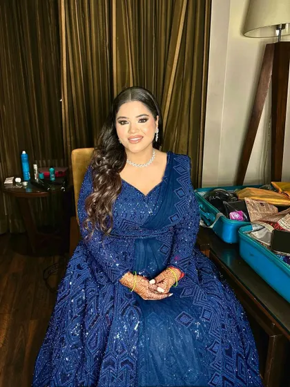 A full shot of this Sangeet bride in her stunning blue gown. The look is cohesive, from the soft makeup to the elegant hairstyle.