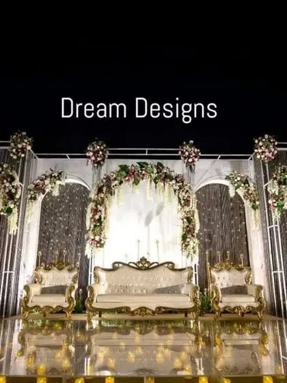 A full view of the sensational iced backdrop stage. The combination of cool-toned structures, warm floral accents, and a candlelit floor creates a design that is both dramatic and romantic.