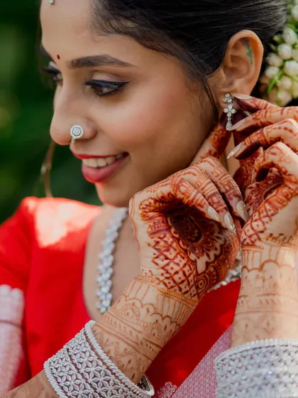 A close-up shot capturing the intricate details of the bride's henna and jewelry. These detail shots are an essential part of telling the complete story of your wedding day.