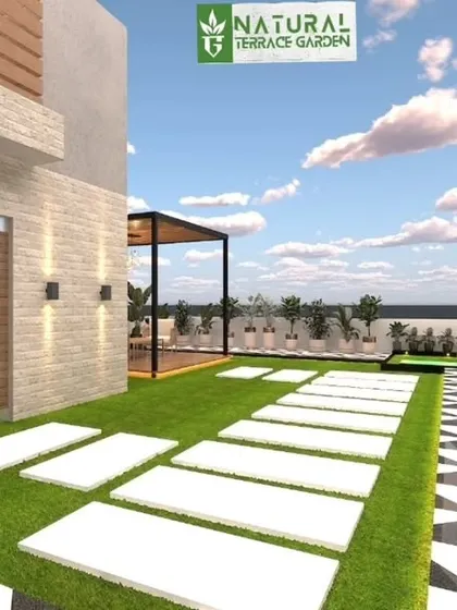 A sunny 3D render of a terrace pathway. The design uses a mix of artificial grass, large white pavers, and patterned tiles to create a visually interesting and practical surface.