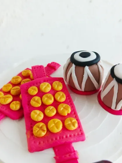 A detailed look at the intricate fondant tabla and ghungroo I created for this special custom cake.
