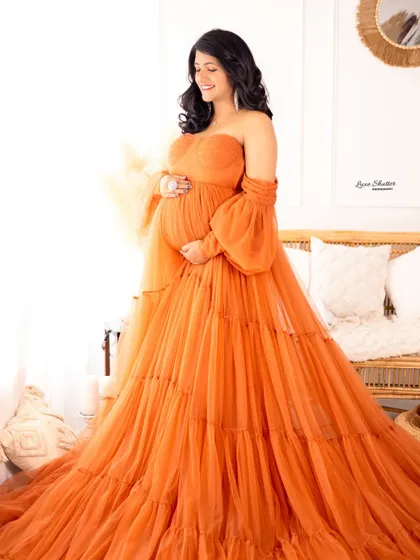 This vibrant orange tiered gown brings so much joy and energy to the portrait. A perfect choice for a mom who loves color.