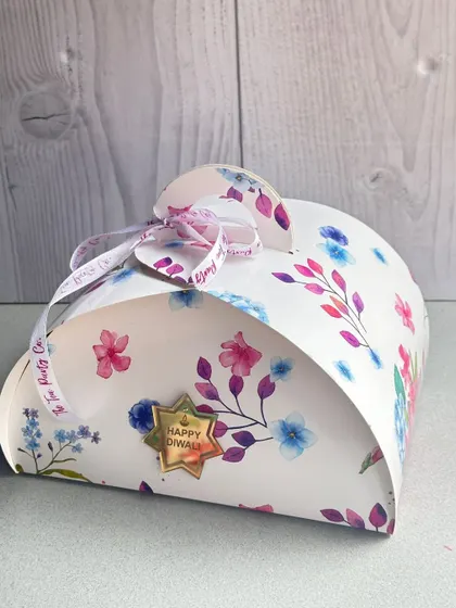Presentation is key, especially for festivals. This is one of my custom-designed gift boxes for Diwali, featuring a beautiful floral print and a signature ribbon.