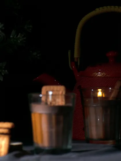 A moody shot of the 'Chai Biscuit' candle, evoking a sense of warmth and nostalgia.