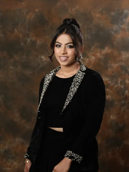 A full shot of the model, looking chic and sophisticated.