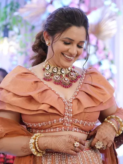 A happy, candid shot of the groom's sister, her makeup looking flawless and radiant.