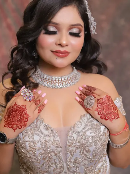 This shot highlights the intricate henna design and the soft, shimmery eye makeup. It's all about the details.