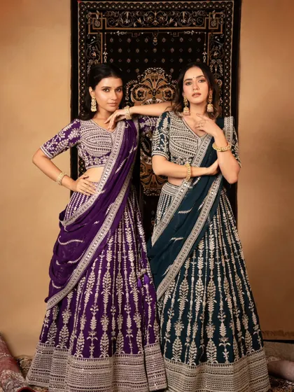 A classic lookbook shot for a lehenga brand, showcasing two different colorways of the same design. The setup is clean and allows customers to easily compare the options.