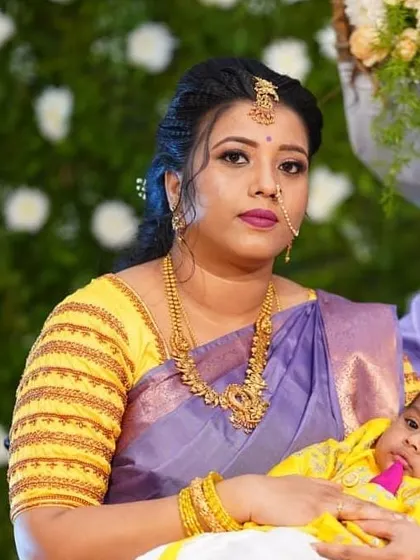 A lovely makeup look for a new mother attending a naming ceremony. The makeup is subtle yet elegant, with a pretty lip colour that complements her purple and yellow saree.