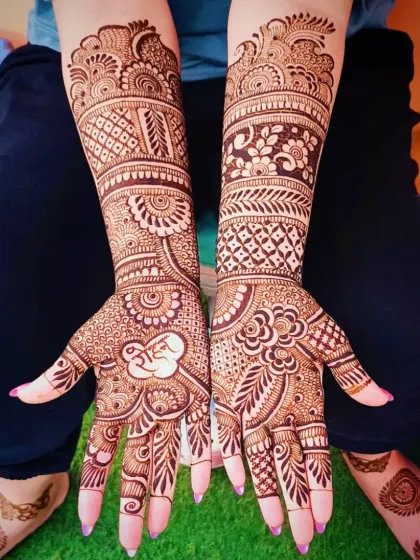 A top-down view of the 'Ram' mehandi, also showing the small design on the client's foot.