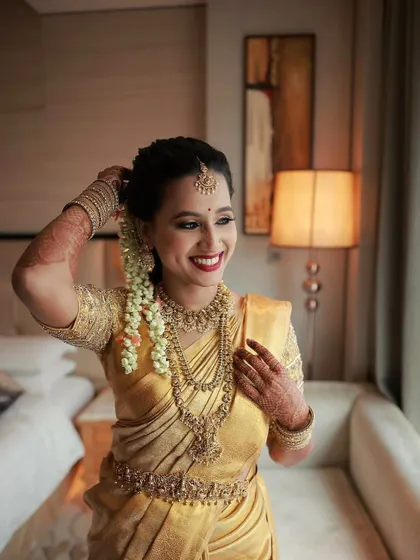 A candid shot showing the bride adjusting her hair. Her makeup remains flawless, highlighting the long-lasting quality of my work.