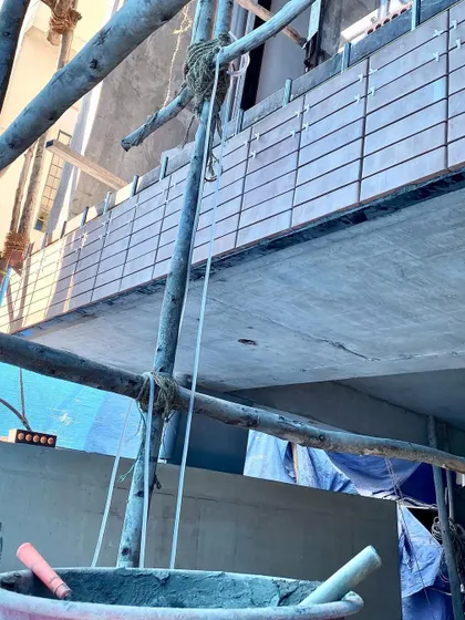 On-site progress of the Jayanagar house, showing the beginning of the facade cladding.