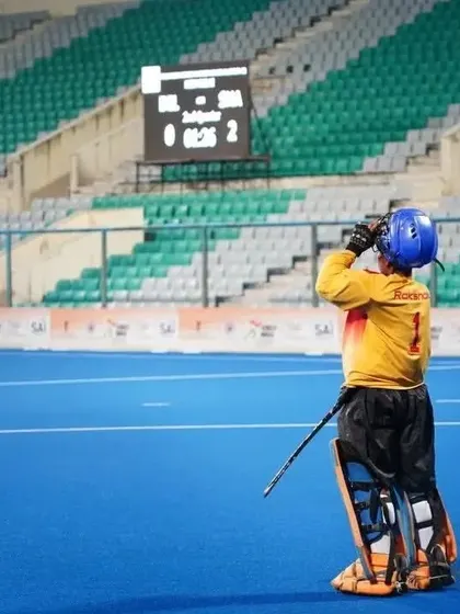 My goalkeeper stands ready and focused, watching the play unfold. A strong defense is the backbone of our team's success, anchored by a confident goalie.